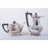 A Regency style silver tea pot, by James Deakin & Sons, Sheffield 1917, of swollen oblong form,