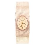 Zenith - A lady's 9 carat yellow gold bracelet watch, having an oval champagne baton dial,