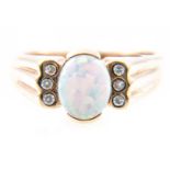 An opal dress ring, the oval cabochon cut opal 9.