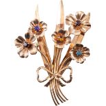 A 9 carat yellow gold floral spray brooch, held together by a bow,