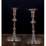 A pair of George II silver table candlesticks of very similar design to the proceeding lot,