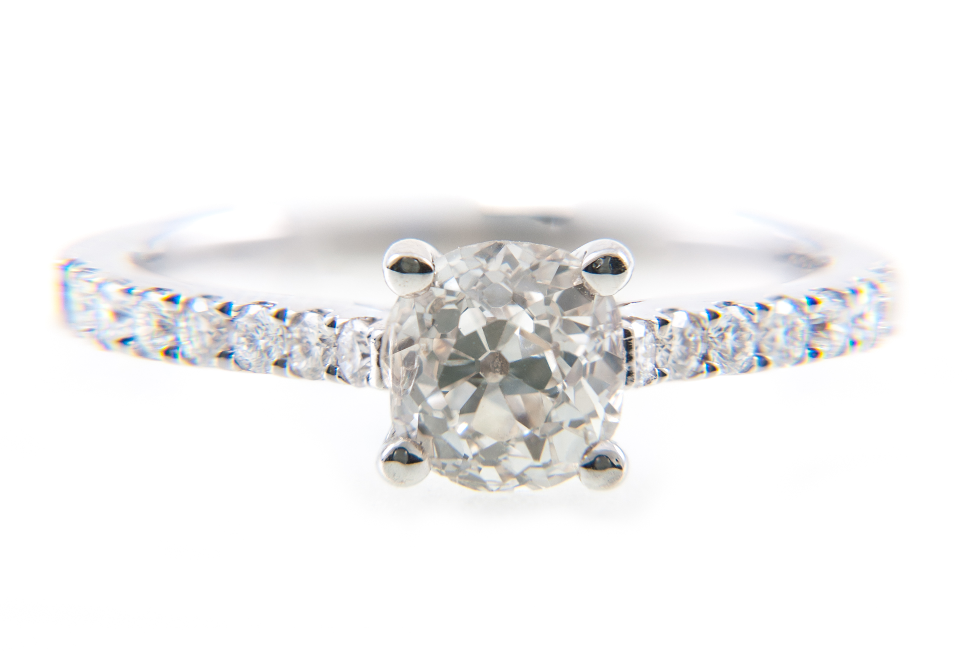 A diamond solitaire ring, the old brilliant cut stone four claw set in an all white metal mount,