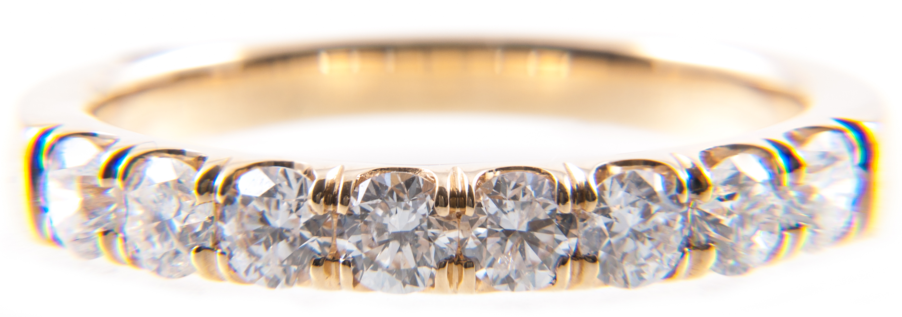 A diamond half eternity ring, eight brilliant cut diamonds claw set in an all yellow metal mount,