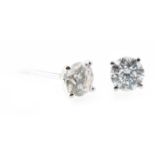 A pair of diamond single stone earrings, one brilliant cut diamond four claw set to each,