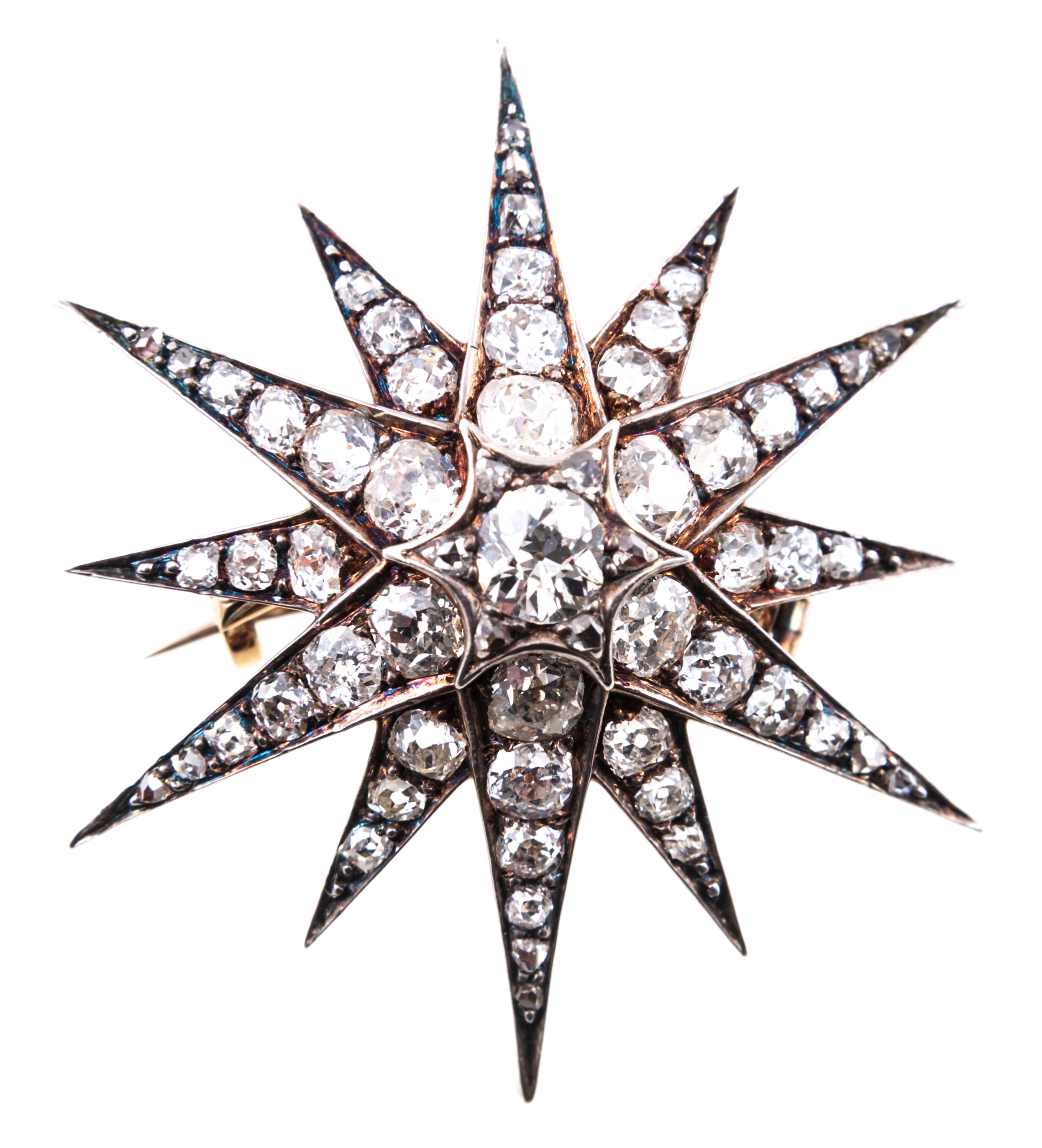 A diamond twelve ray star brooch/pendant,