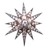 A diamond twelve ray star brooch/pendant,