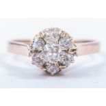 A diamond circular cluster ring, seven old brilliant cut diamonds,