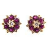 A pair of ruby and diamond circular cluster earrings, six rubies spaced by six,