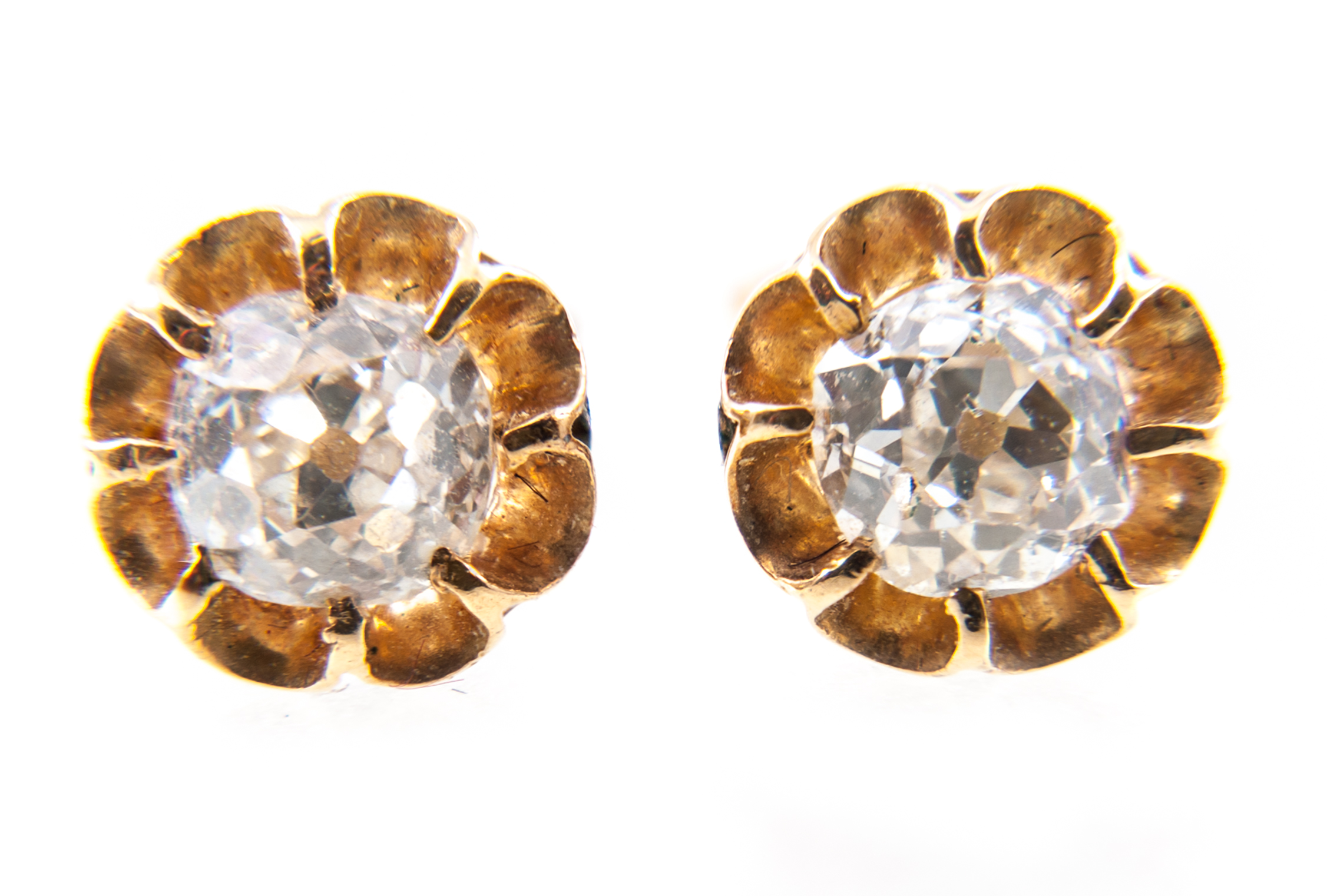 A pair of diamond single stone earrings, one old brilliant cut diamond eight claw set to each,