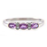 A pink sapphire and diamond half hoop ring,