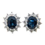 A pair of sapphire and diamond oval cluster earrings, an oval faceted sapphire 6.6mm x 4.