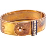 A yellow metal half hinged buckle bangle,