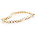 An all yellow metal diamond set tennis design bracelet, forty-four brilliant cut diamonds,