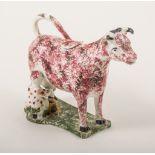 A Pratt type cow and milkmaid creamer, perhaps North-East region, 1800-1820, red and black sponged,