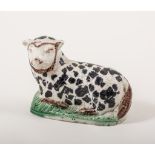 A Pearlware hollow-base model of a recumbent ewe, Staffordshire or Yorkshire, circa 1800, 10cm.