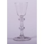 A wine glass, probably mid 18th century, rounded funnel bowl, double knop stem, folded foot, 15cm.