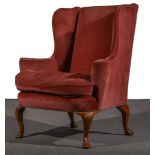 A George I style walnut wing-back easy chair, upholstered in salmon coloured dralon,