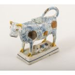 An earthenware, cow and calf model, Staffordshire or Yorkshire, 1800-1820, modelled with a calf,