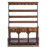 A Joined oak dresser, basically early 19th century, three shelf delft rack,