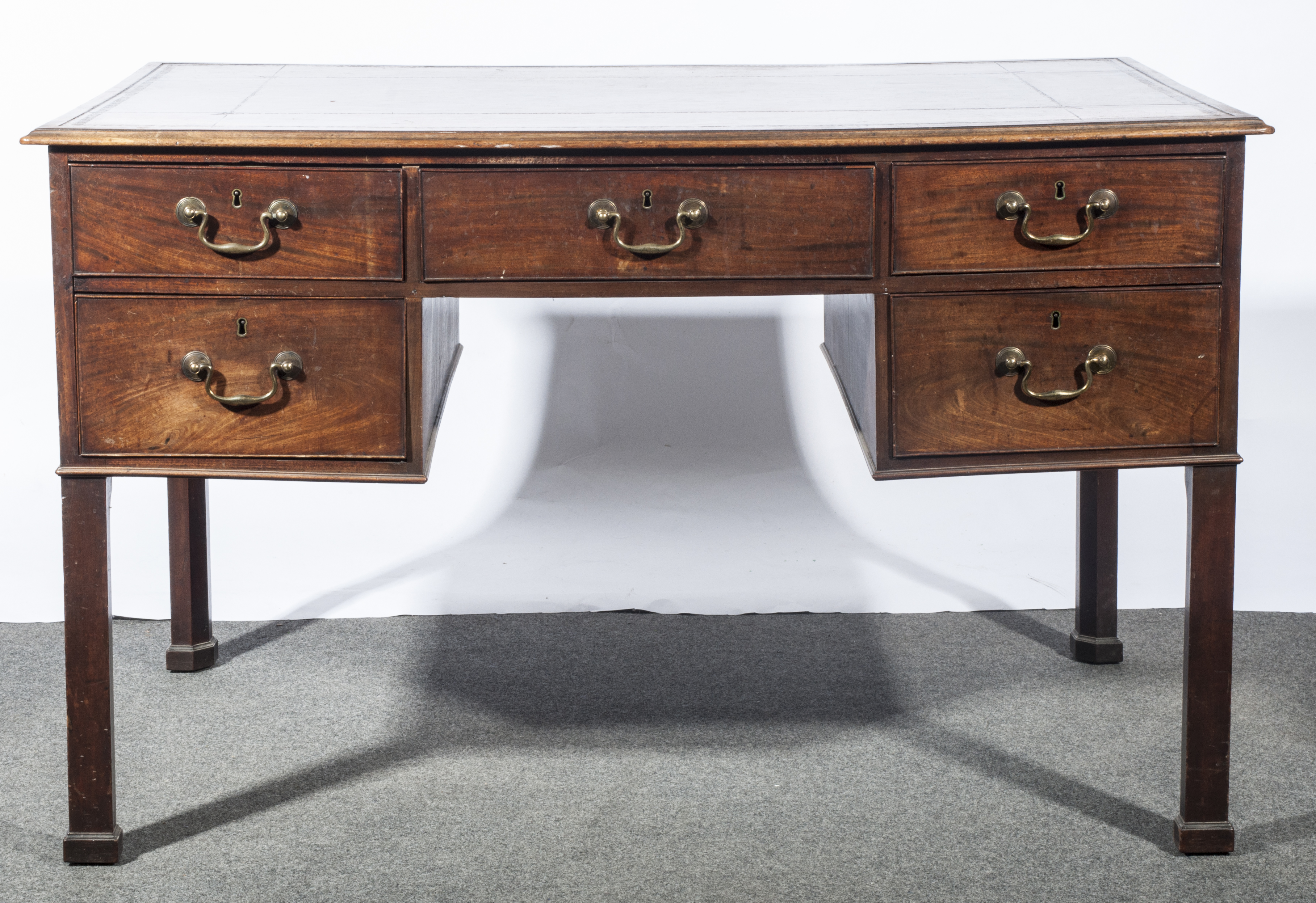 A George IV mahogany desk, tooled leather inset, fitted with five drawers,