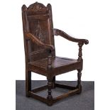 A joined oak Wainscot chair, 18th century and later adaptations, carved and scrolled pediment,