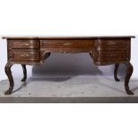 A German oak desk, serpentine rectangular top with quartered walnut veneers, rosewood crossbanding,