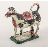 A Pratt type cow and milkmaid creamer, circa 1800-1820, dappled in black and ox blood red,