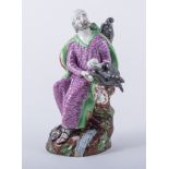 A Pearlware type figure, 'Elijah and the Ravens', painted in colours, old damage, 21cm.