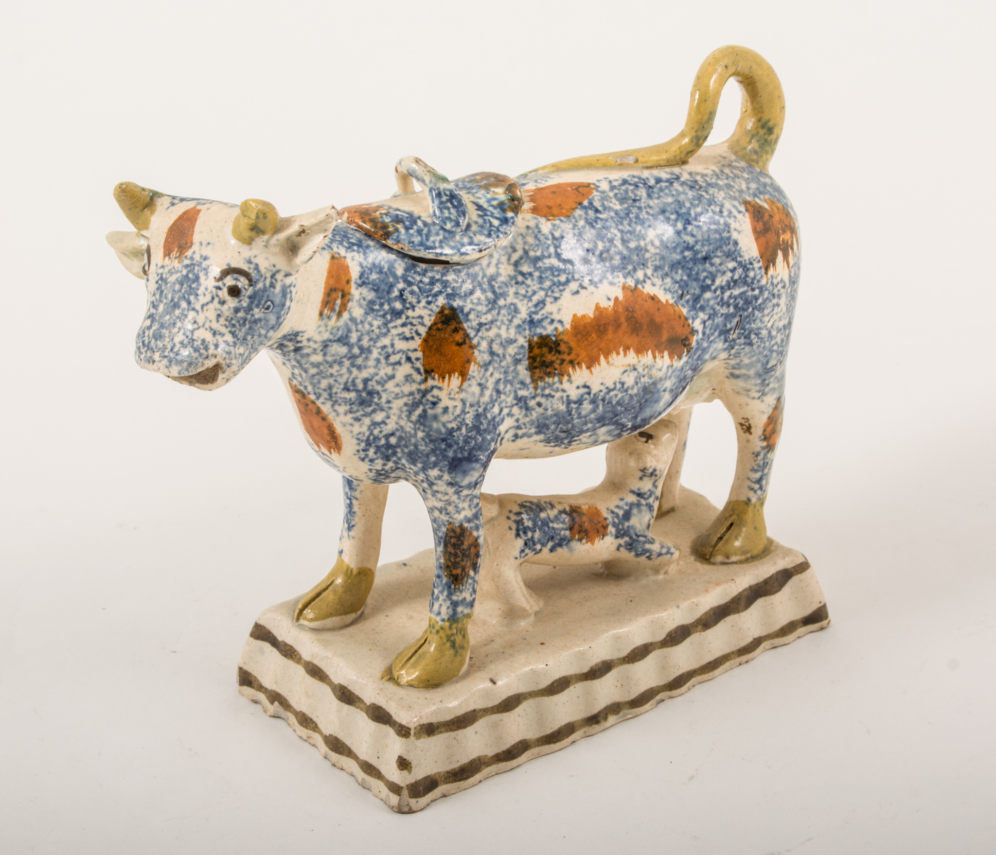 A Creamware cow creamer, probably Yorkshire, circa 1800, sponge decoration in blue,