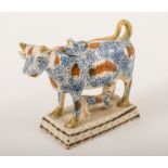 A Creamware cow creamer, probably Yorkshire, circa 1800, sponge decoration in blue,