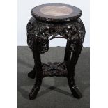 A Chinese carved hardwood stand, circular top with a marble inset, feather-edge moulding,
