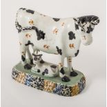 A small Creamware type cow creamer, Staffordshire or Yorkshire, mottled blue with ochre patches,