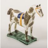 A Pearlware model of a saddled horse, attributed to St.