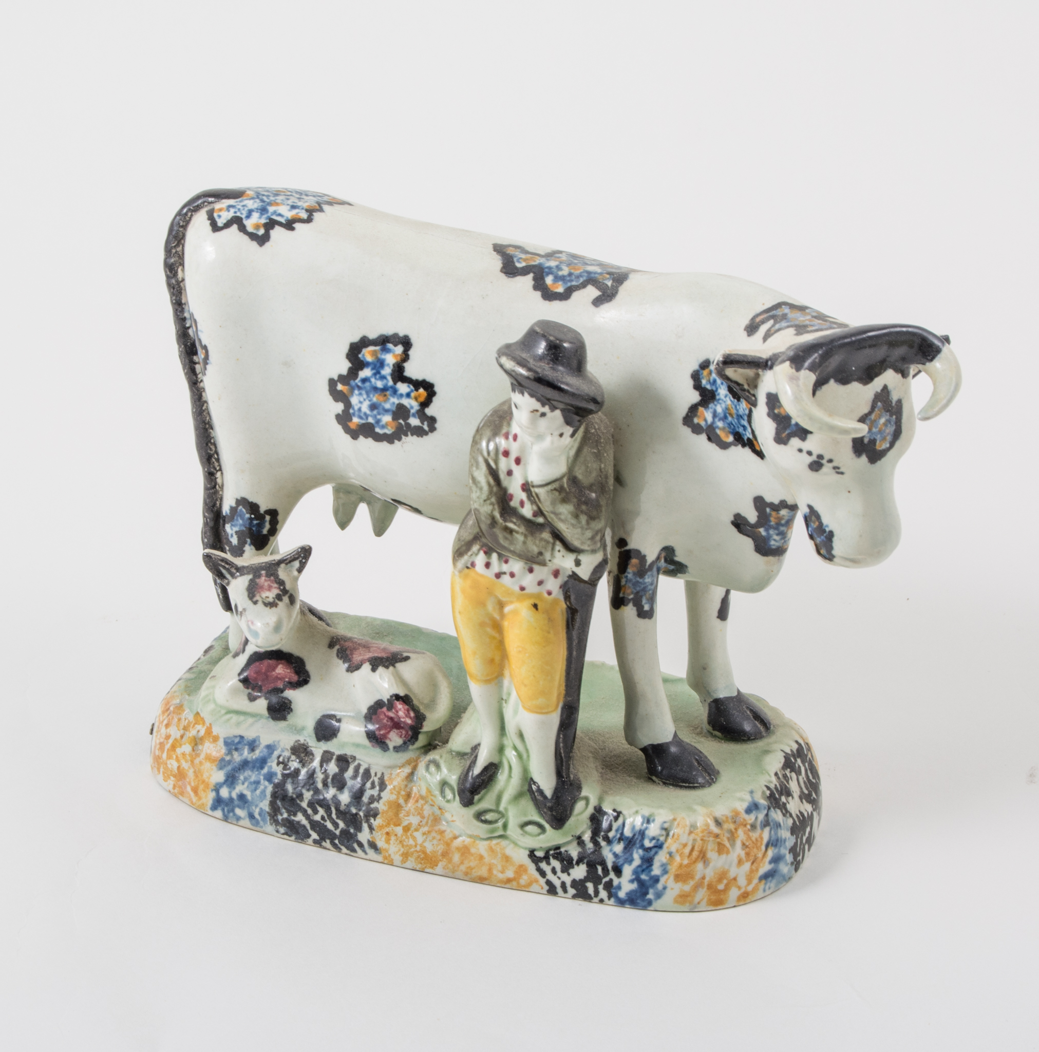 A Prattware, cow, calf and gardener group, Yorkshire, 1800-1820,