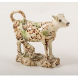 A Staffordshire Creamware type cow and calf creamer, late 18th century with sponged oxide glazing,