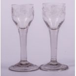 A near pair of wine glasses, late 18th century, ogee bowls, wheel engraved,