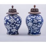A near pair of Chinese porcelain blue and white baluster shaped jars, decorated with blossom,