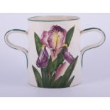 A Wemyss two-handled loving cup, circa 1900, decorated with irises, probably painted by Karl Nekola,