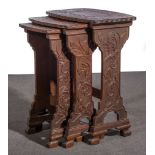 A nest of three Sino-European carved hardwood tables, early 20th century, bowed form,