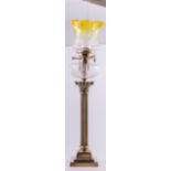 A brass Corinthian column oil lamp, square stepped base, fluted shaft with cut glass reservoir,