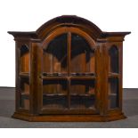 A Dutch oak wall cabinet, 18th century, arched centre, deep cavetto moulded,