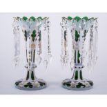 A pair of Victorian overlaid green glass trumpet shape lustre vases, with Gothic style decoration,