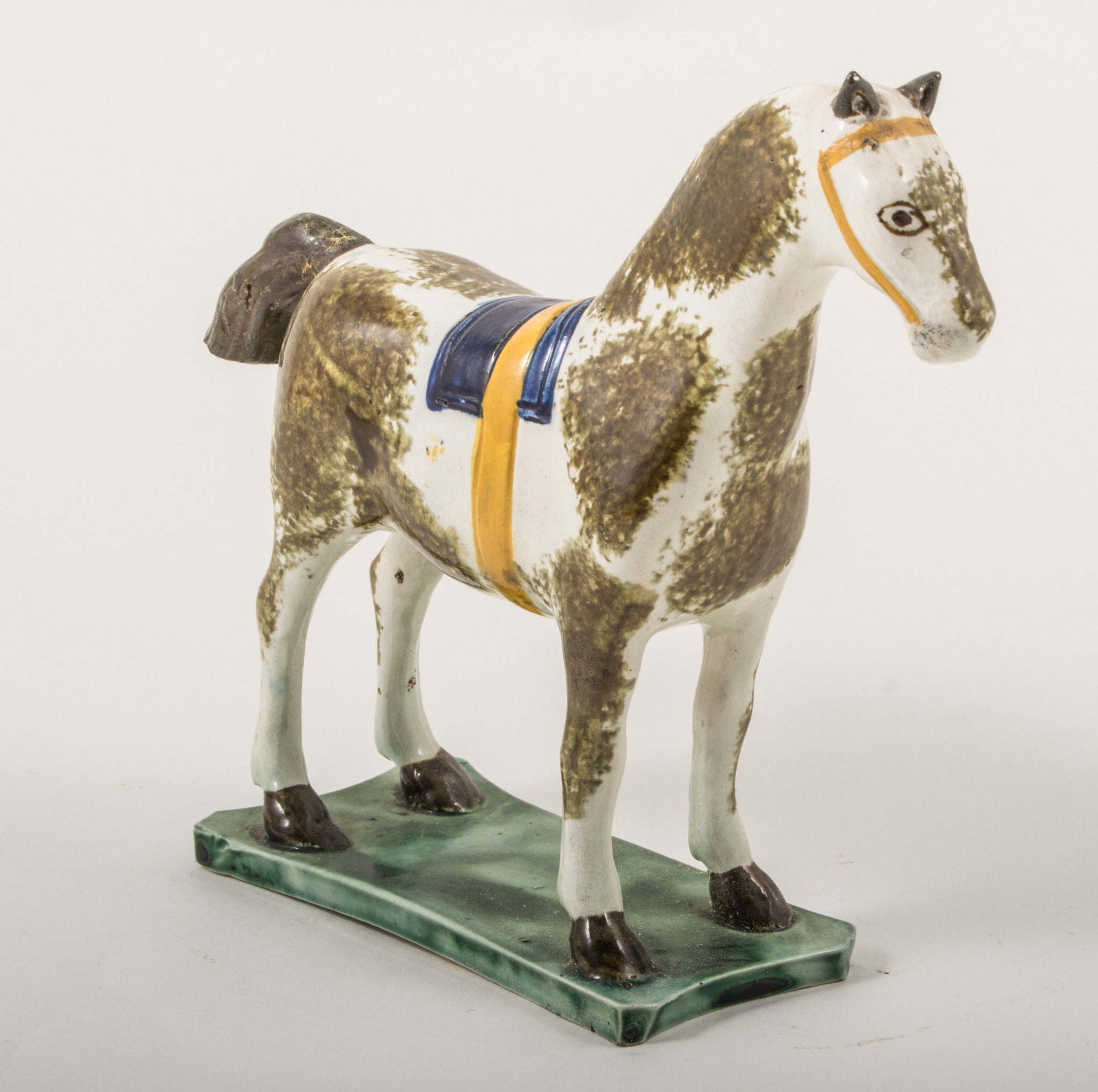 A Pearlware model of a saddled horse, attributed to St.