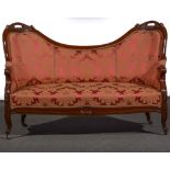 A Victorian walnut framed settee, double chair back with carved scrolled cresting, moulded frame,