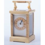 A French brass cased carriage clock, gilt chapter ring with Arabic numerals, signed by the retailer,