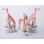 A pair of Staffordshire models of seated greyhounds, shaped bases,