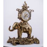A Louis XV style gilt metal elephant clock, drum-shaped case resting on a ceremonial elephant,