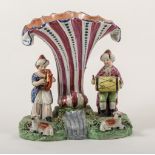 An enamelled earthenware musicians spill vase group, Staffordshire, circa 1820,