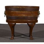 A George III style oak and walnut wine cooler, oval form,