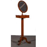 A Victorian mahogany shaving mirror on stand, adjustable oval mirror, over two hinged compartments,